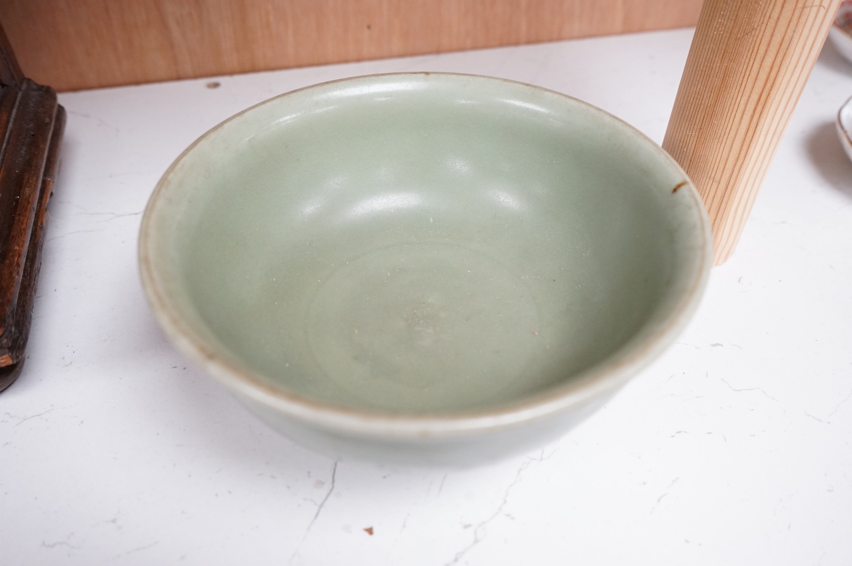 A Chinese celadon glazed bowl with incised decoration, 16cm diameter. Condition - good